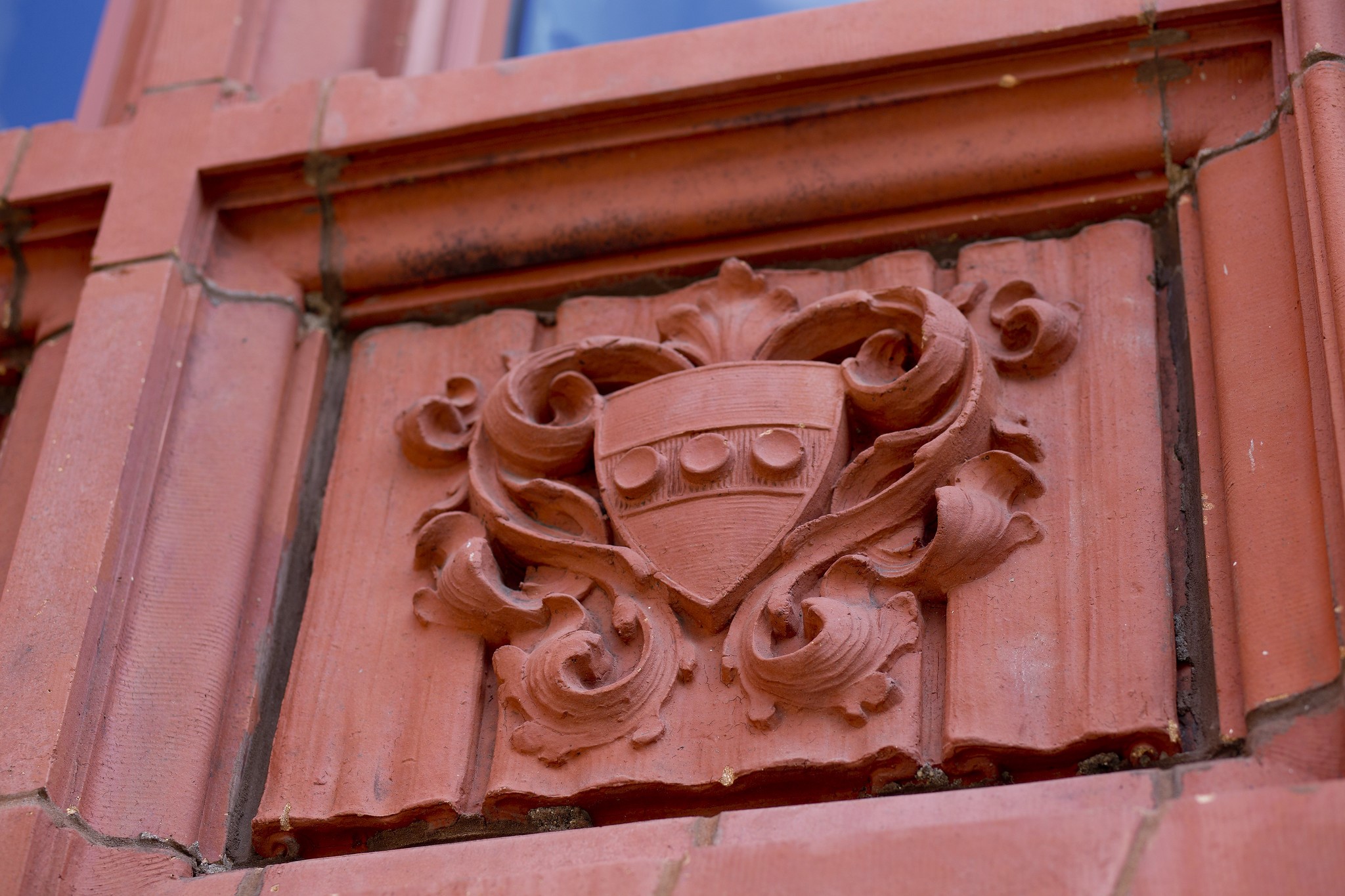 Penn shield in brick on the side of a building