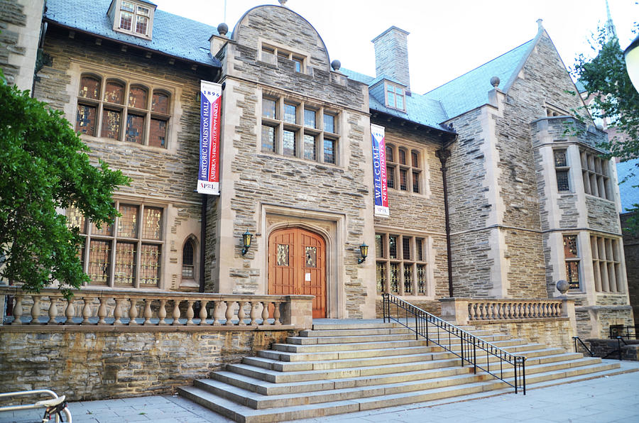 The South side of Houston Hall. A Stone Building with large stairs leading up to a central wooden door.